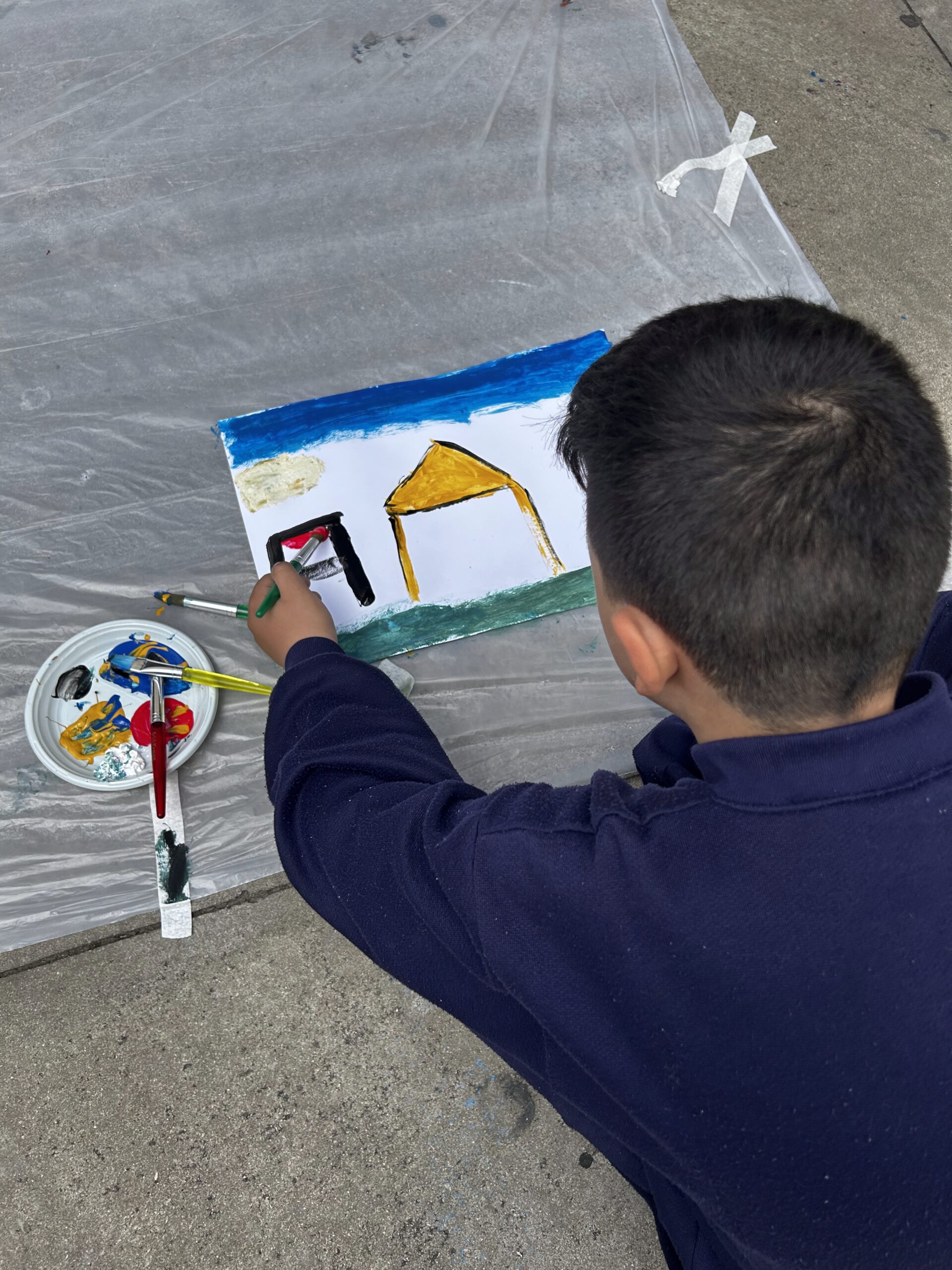 04_Boy_painting_house_closeup